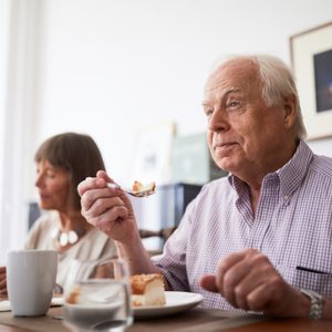 man eating with his family