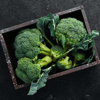 Broccoli. Fresh green broccoli on a black stone table. Top view. Free copy space.