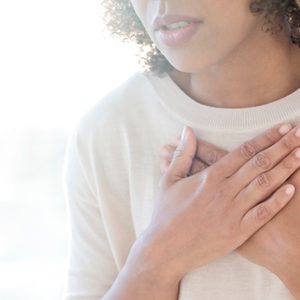 woman touching chest