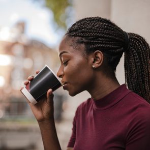 woman drinking a cup of coffee