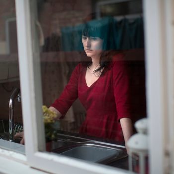 Disappointed woman standing in kitchen