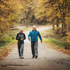 Senior couple power walking in a park.