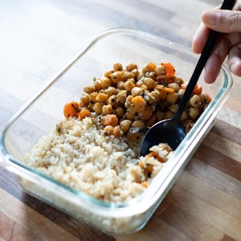 person eating food leftovers from container