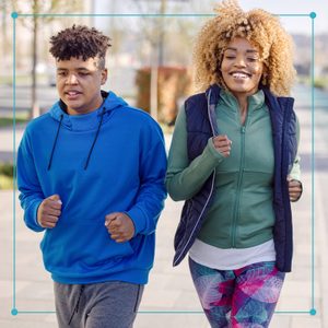 Mother and son walking fast in a public park