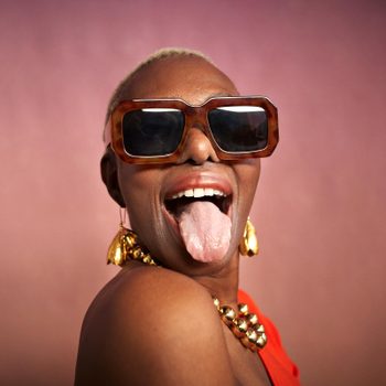 portrait of a woman in sunglasses sticking out her tongue