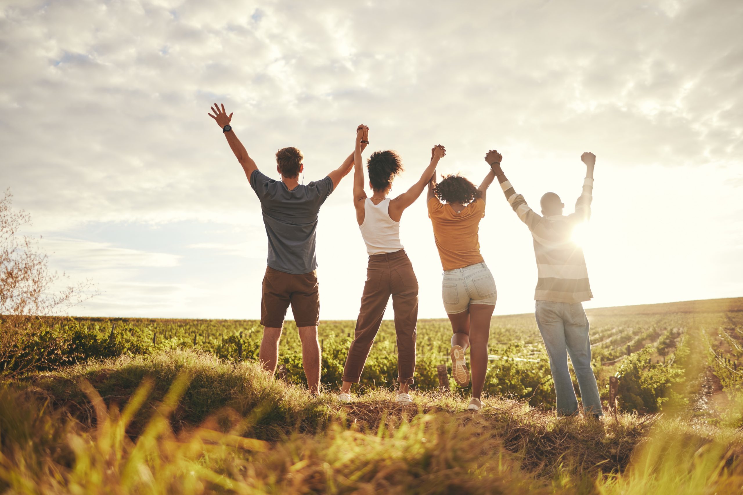 Farm, Celebration And Sustainability People Holding Hands For Teamwork, Earth Day And Growth Goal Achievement. Group Friends Celebrate Ecology, Farming Or Countryside Agriculture Travel In Sunset